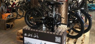 Grey Axon Electric Bikes on Retail Display Stand