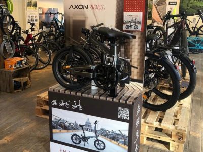 Grey Axon Electric Bikes on Retail Display Stand
